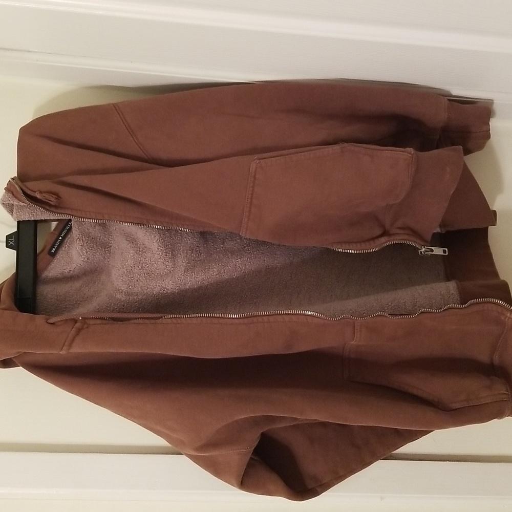 Brandy Melville zip-up hoodie with two pockets and a drawstring hood. 